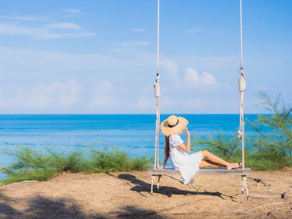 portrait-beautiful-young-asian-woman-relax-smile-swing-around-beach-sea