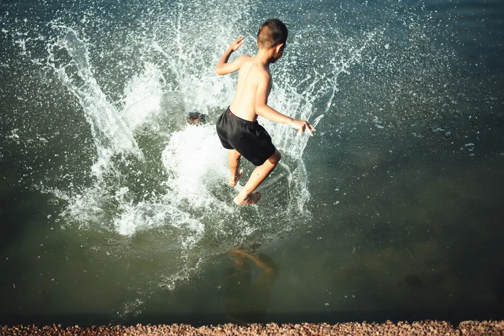 active-boy-jumping-into-the-water