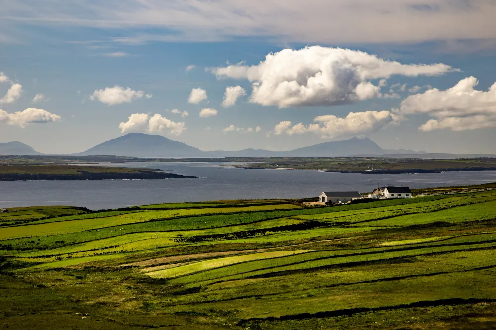 high-angle-shot-of-a-valley-next-to-the-sea-in-the-near-ballycastle