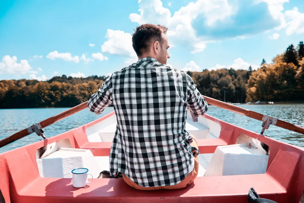 rear-view-of-man-kayaking-and-admiring-the-view