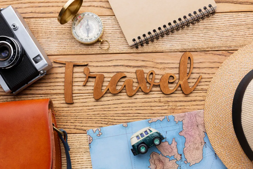 top-view-traveling-items-on-wooden-background