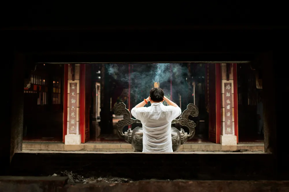 back-view-man-praying-temple-with-burning-incense
