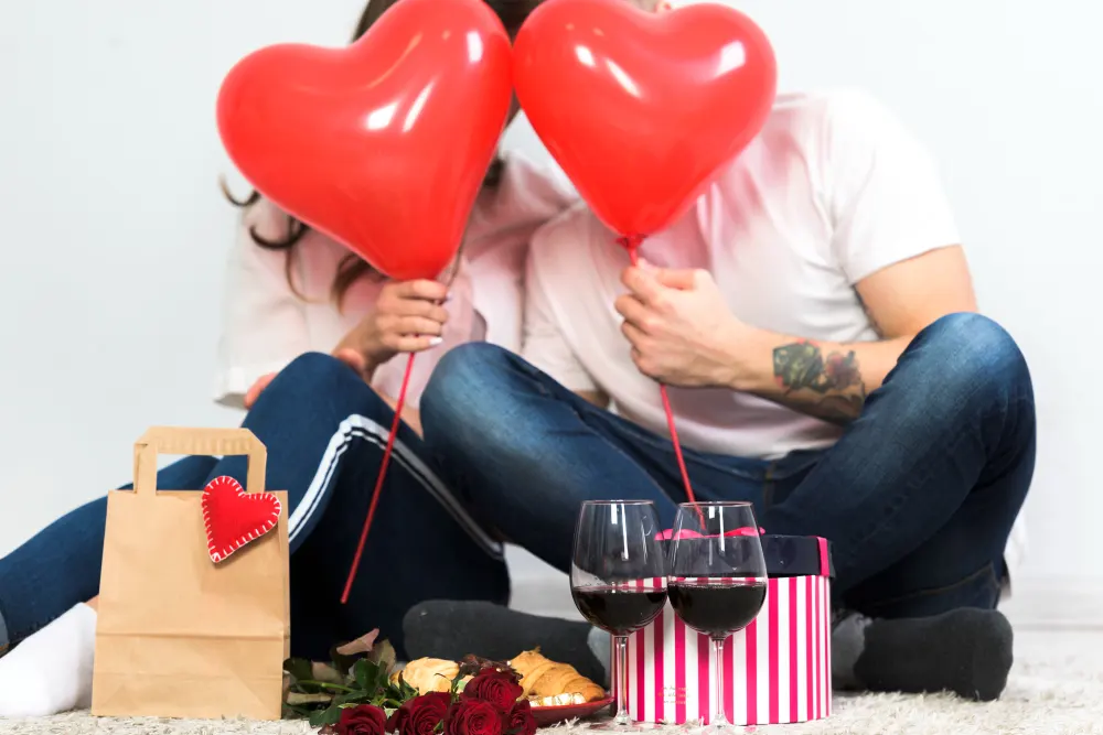 couple-covering-faces-with-red-heart-balloons