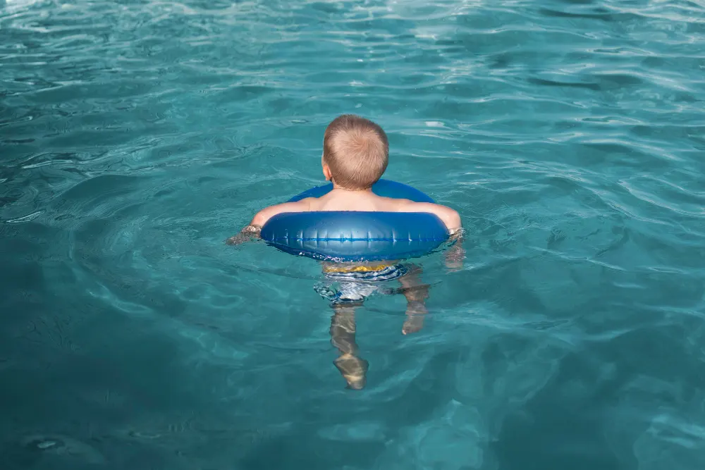 full-shot-kid-swimming-with-lifebuoy