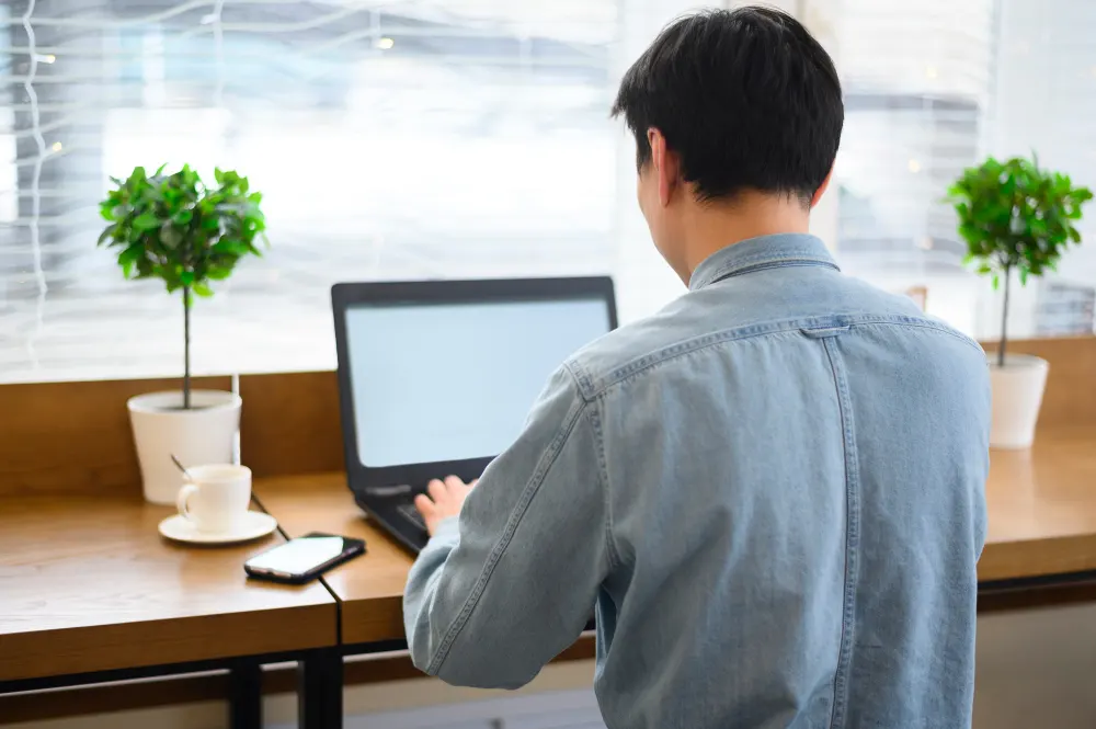 high-angle-male-working-laptop