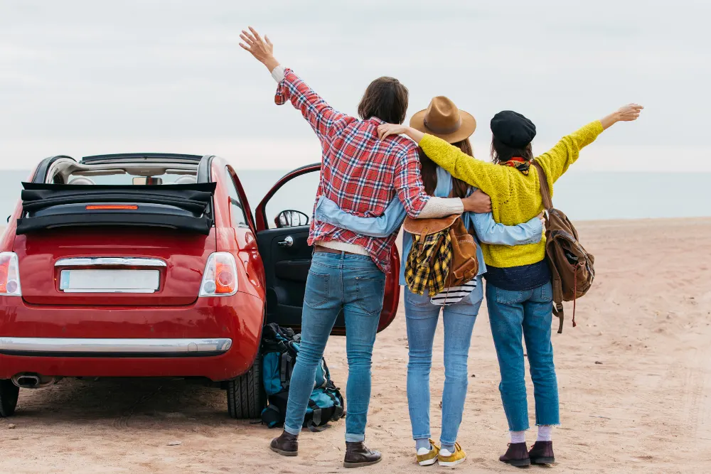 man-women-embracing-near-car-sea-coast