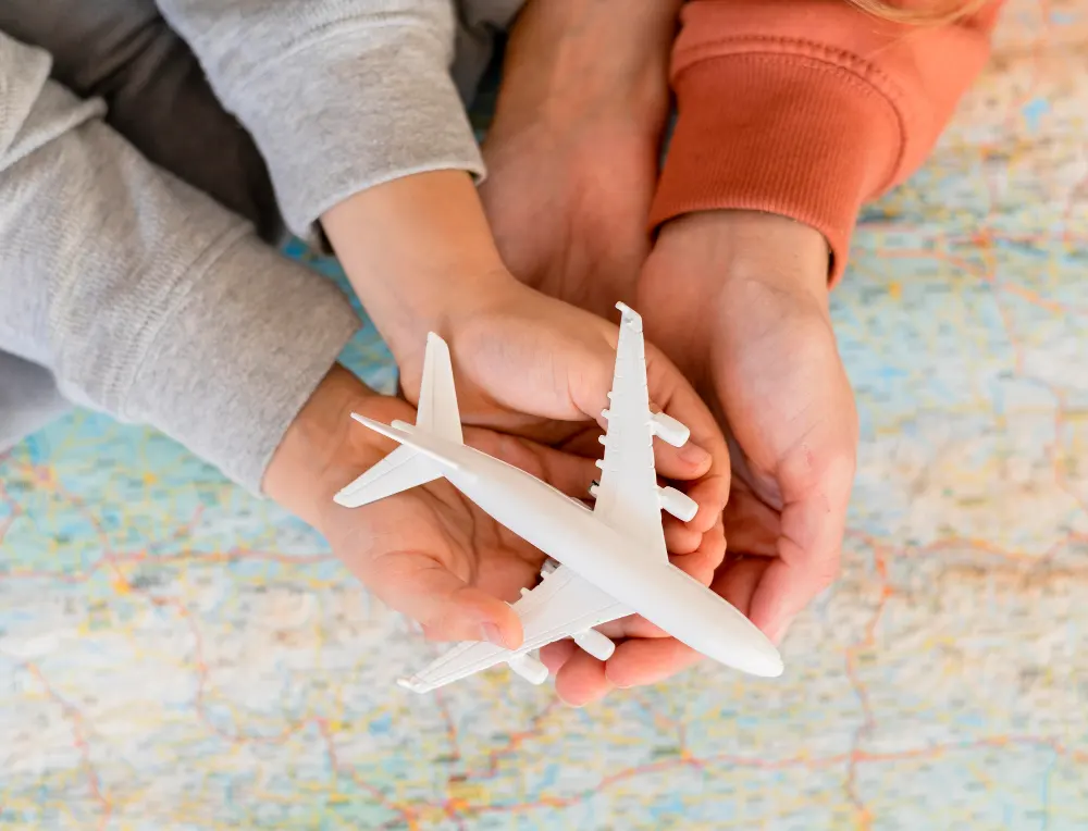 mother-child-home-holding-airplane-figurine-top-map