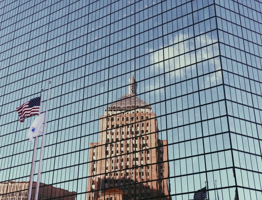 the-american-flag-and-tall-building-reflection