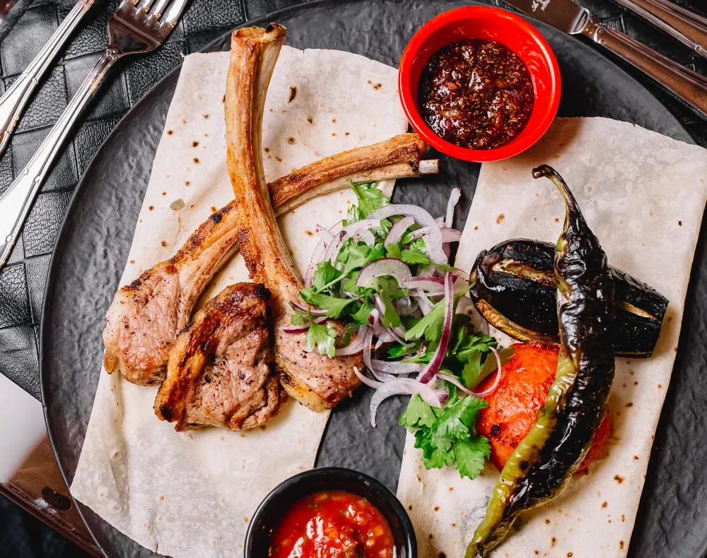 top-view-azerbaijani-ribs-kebab-served-with-grilled-vegetables-flatbread
