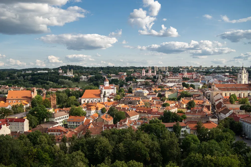 vilnius-city-surrounded-by-buildings-greenery-sunlight-cloudy-sky-lithuania