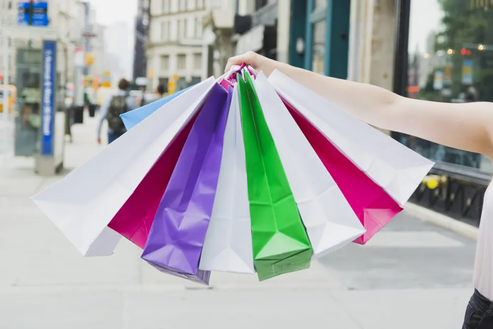 woman-holding-colourful-shopping-bags