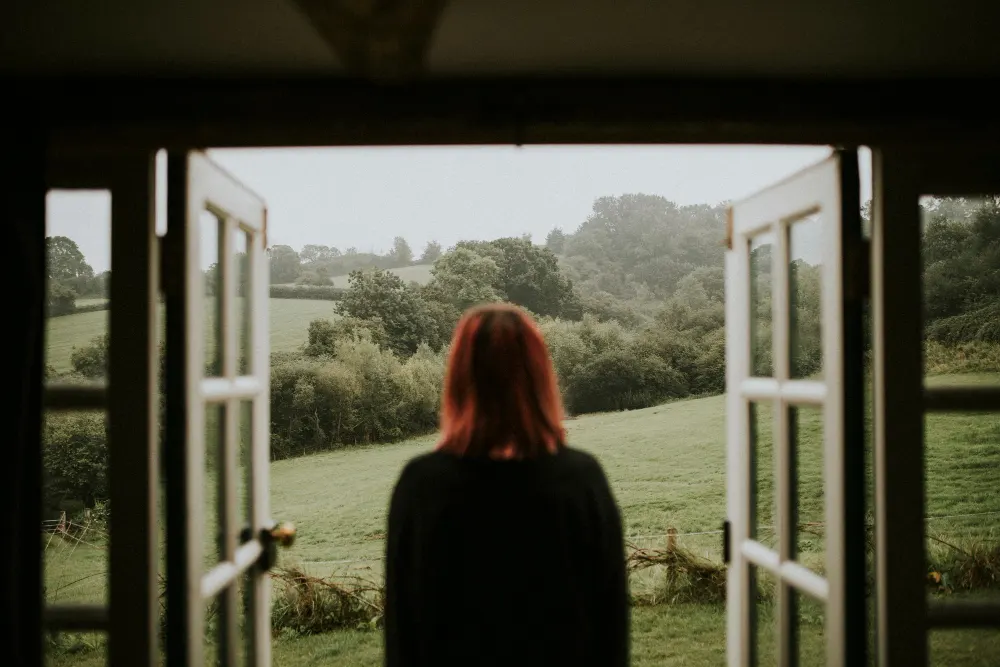 woman-standing-front-house