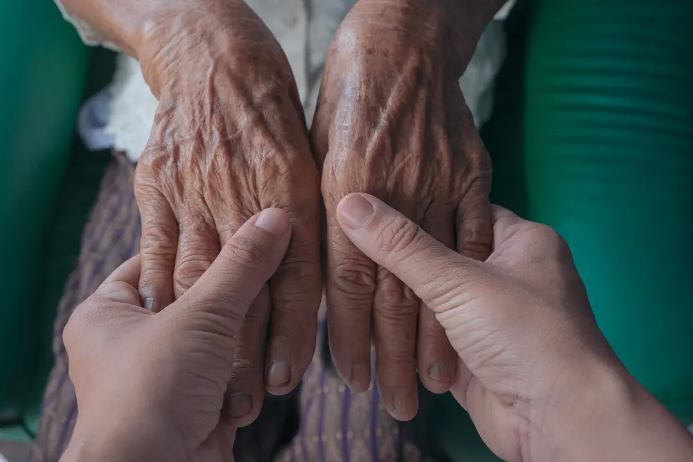 young-woman-holding-elderly-woman-s-hand