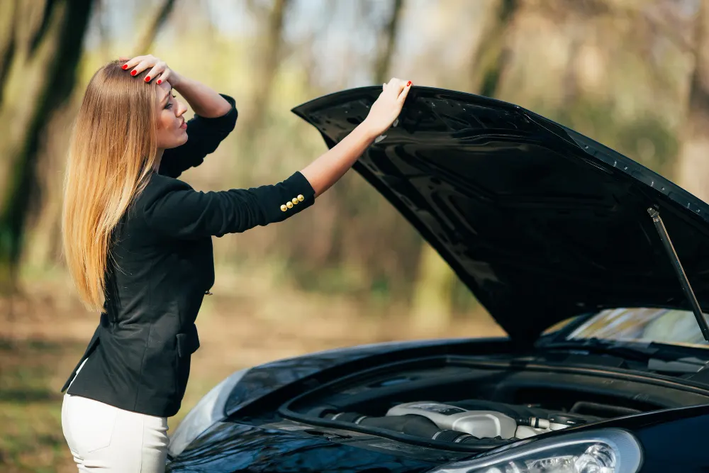 a-woman-waiting-for-an-assistance-near-her-car