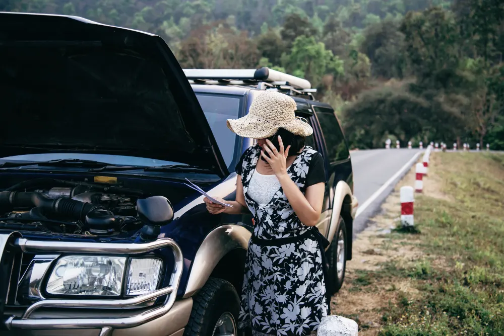 asian-woman-calling-repairman-or-insurance-staff-to-fix-a-car-engine-problem