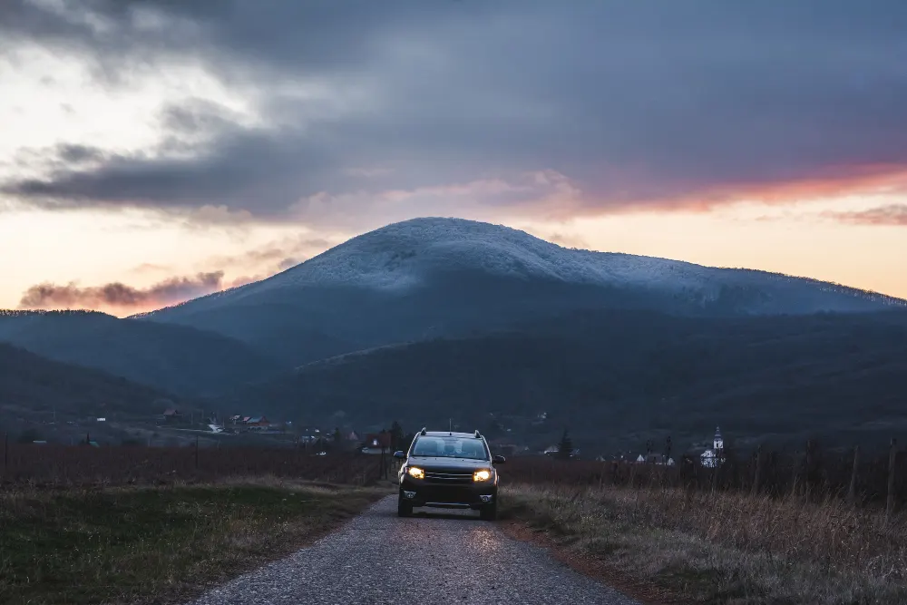 car-on-the-road-with-a-mountain-during-the-sunset