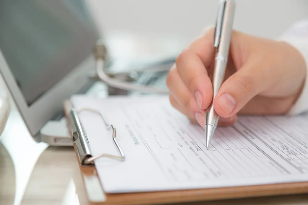 close-up-of-doctor-filling-out-a-prescription