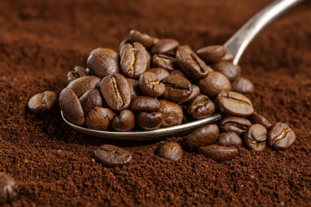 coffee-beans-on-spoon-on-ground-coffee