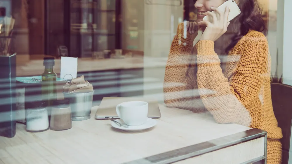 crop-woman-speaking-on-phone-in-cafe