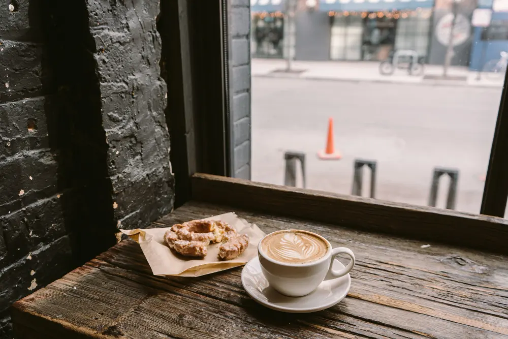 cup-of-coffee-next-to-a-cookie-put-on-the-windowsill