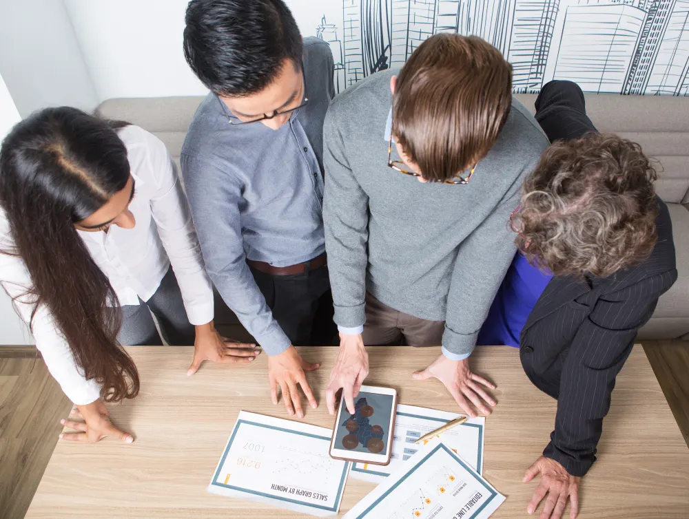 four-business-colleagues-discussing-diagrams