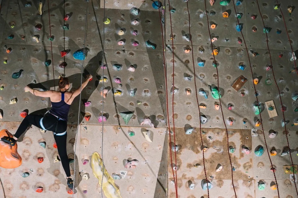 woman-climbing-high-wall