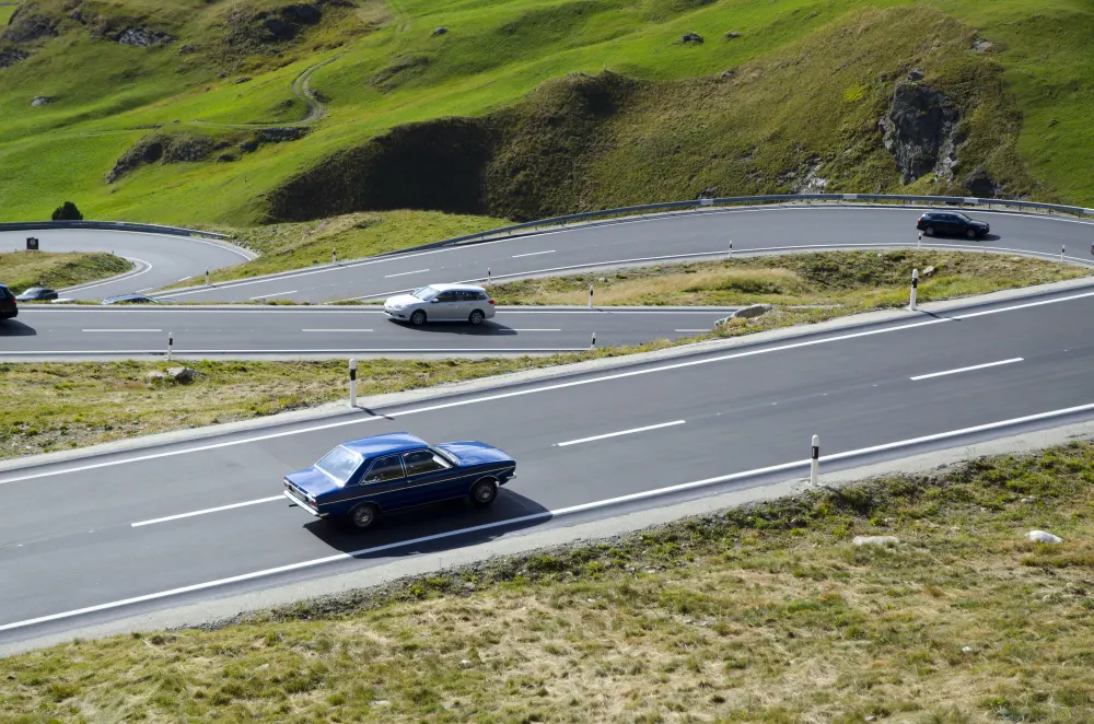 high-angle-view-of-cars-on-the-curvy-road-surrounded