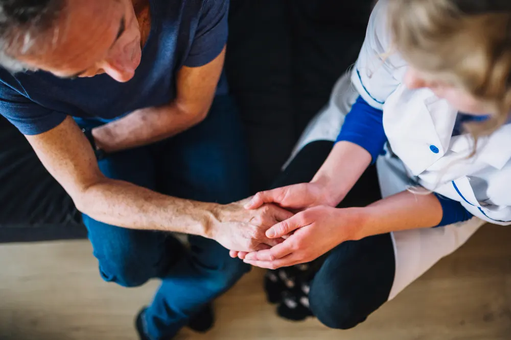 man-in-old-age-home-holding-hand-of-nurse