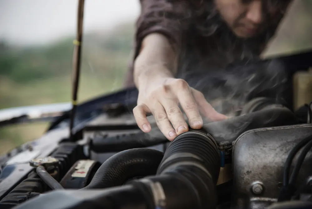 man-try-to-fix-a-car-engine-problem-on-a-local-road