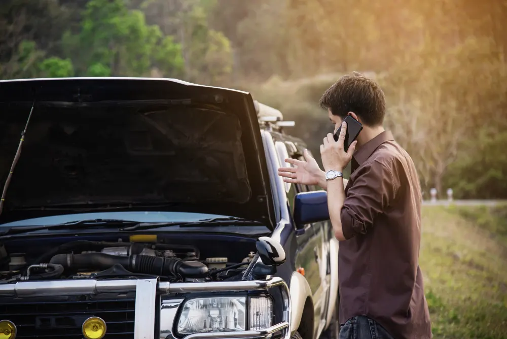 man-try-to-fix-a-car-engine-problem-on-a-local-road