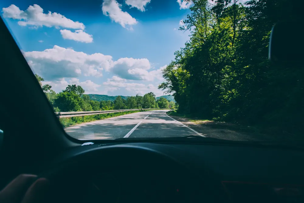 point-of-view-shot-of-a-person-driving-a-vehicle-on-the-countryside-road