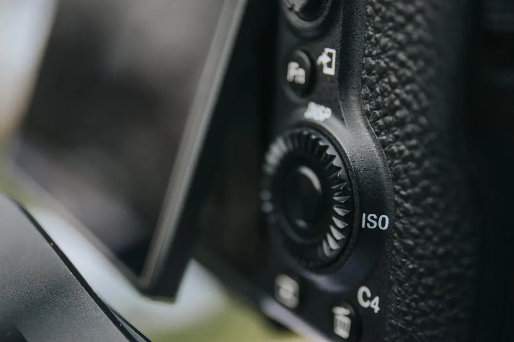 selective-focus-shot-of-iso-button-of-a-digital-camera-with-flip-screen