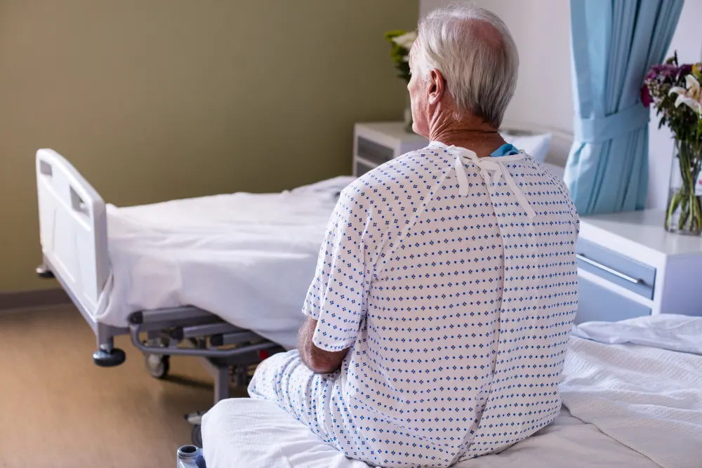 thoughtful-male-senior-patient-sitting-in-the-ward