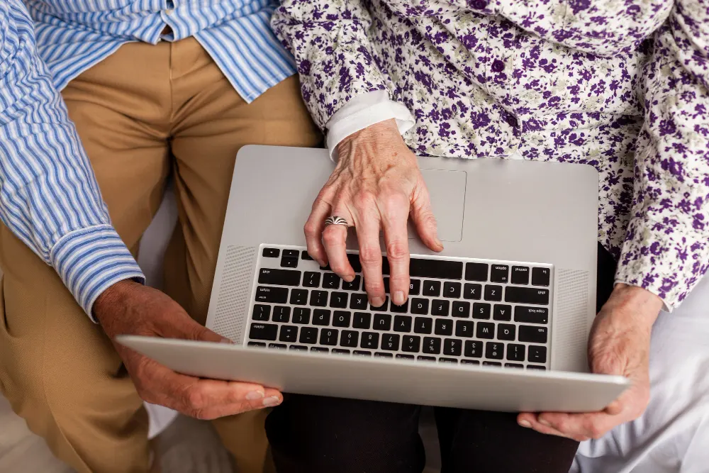 top-view-senior-couple-using-a-laptop