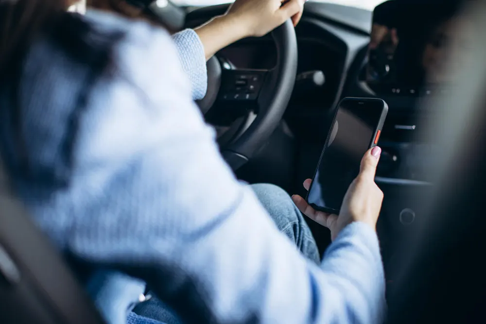 woman-using-phone-while-driving-in-car