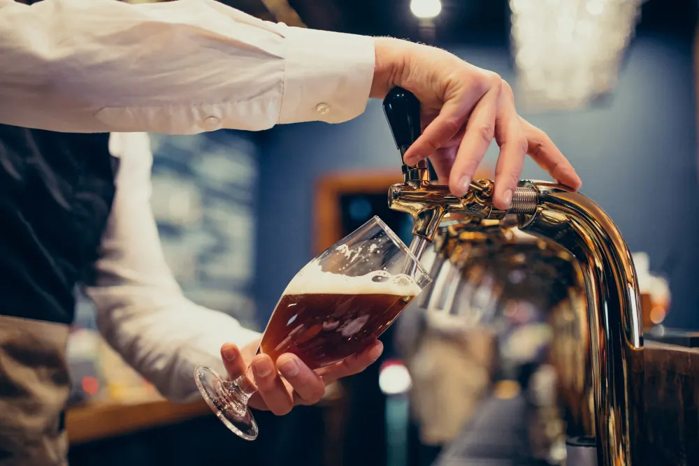 male-bartender-pouring-beer-pub