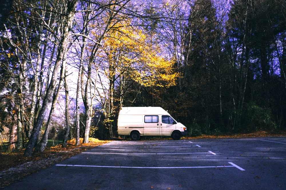 motorhome-parked-parking-lot-forest-camping-adventure-concept