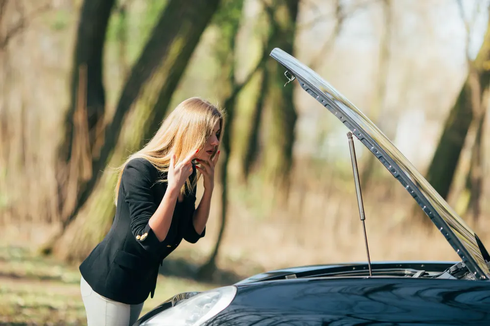 woman-waits-assistance-near-her-car-broken-down-road-side