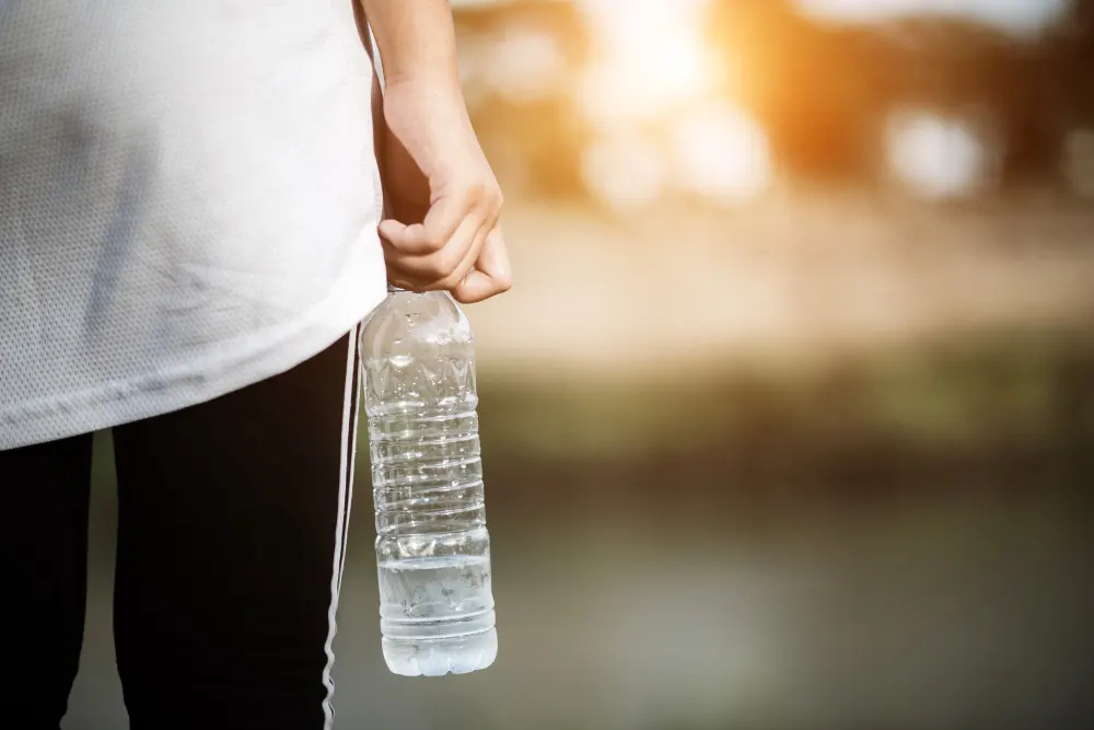 young-fitness-woman-holding-water