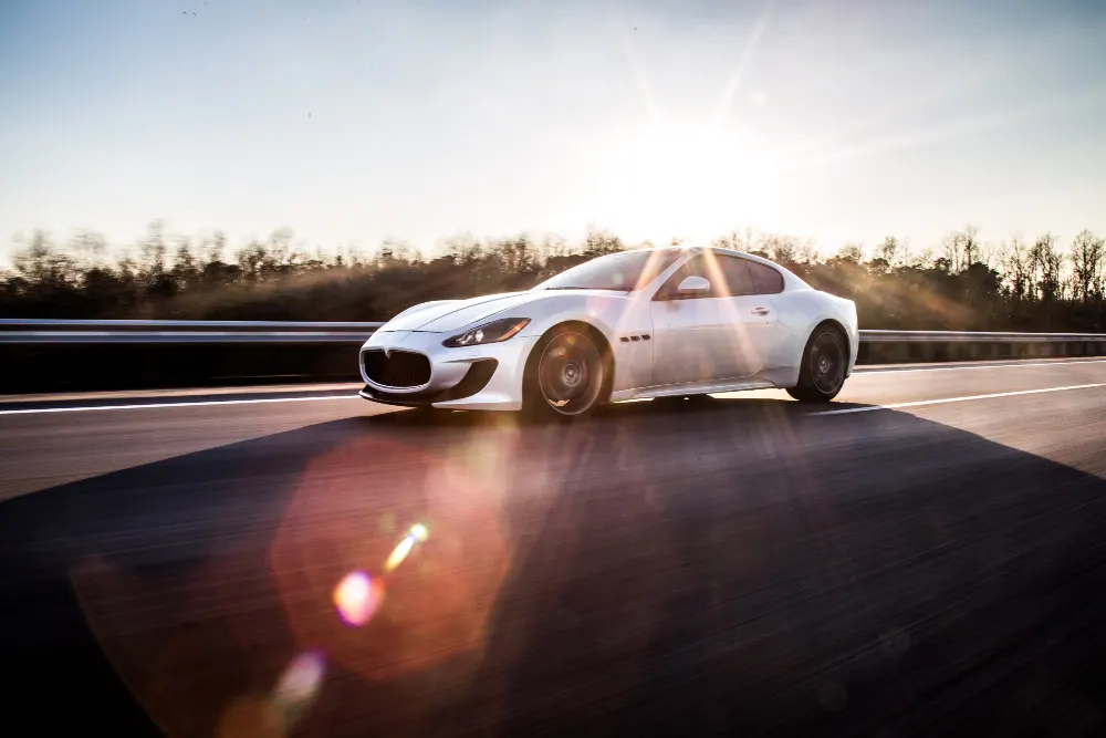 a-high-speed-silver-sport-car-driving-on-the-highway