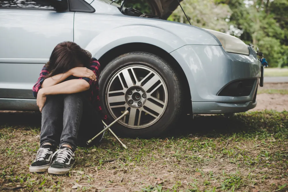 woman-waiting-for-roadside-assistance-after-her-car-breaks-down