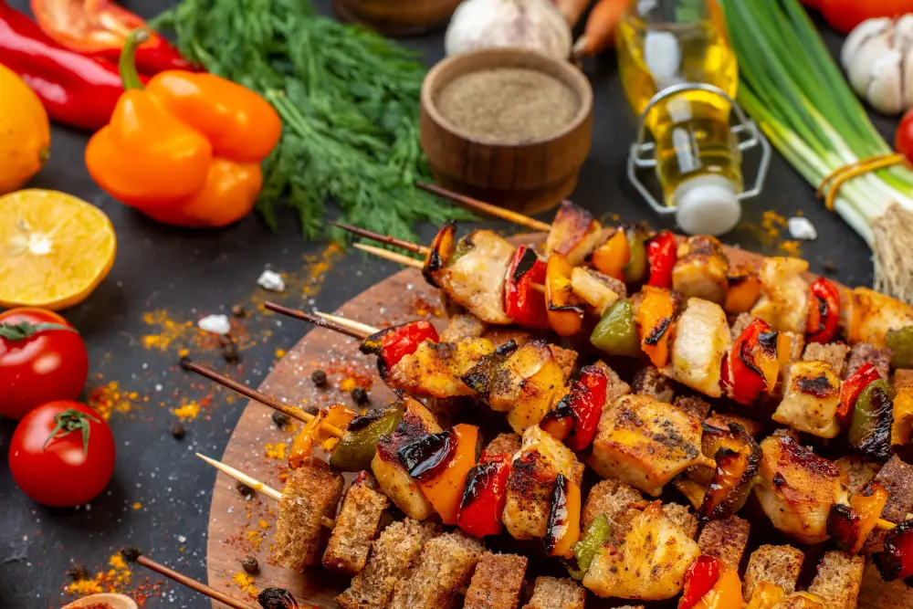 bottom-view-roasted-chicken-skewers-on-wooden-board