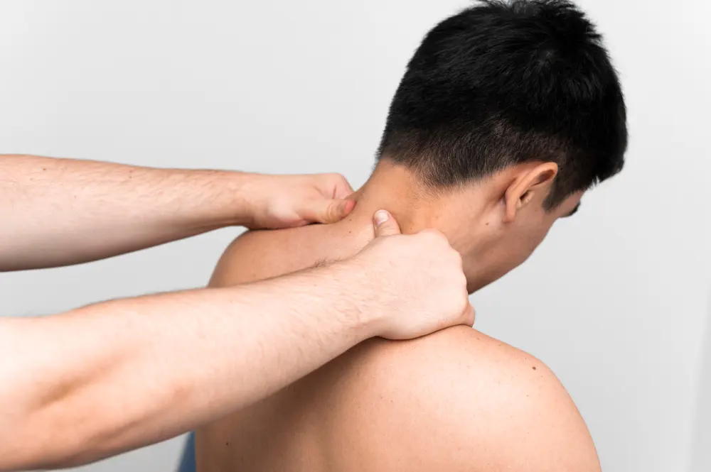 male-patient-getting-neck-massage-from-physiotherapist