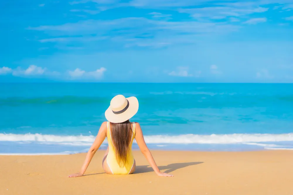 Young-woman-sitting-relax-on-the-beach