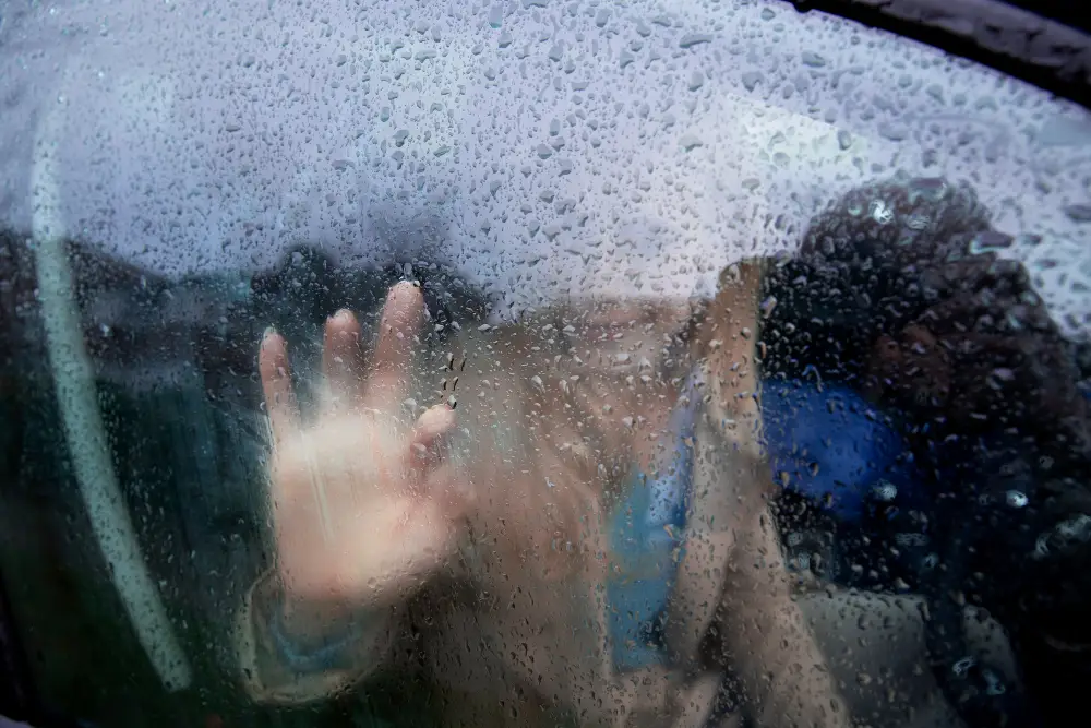 woman-looking-outsid-the-car-window-while-it-rains