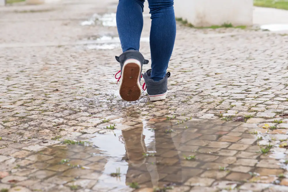 close-up-of-unrecognizable-woman-walking-on-stone-pathway