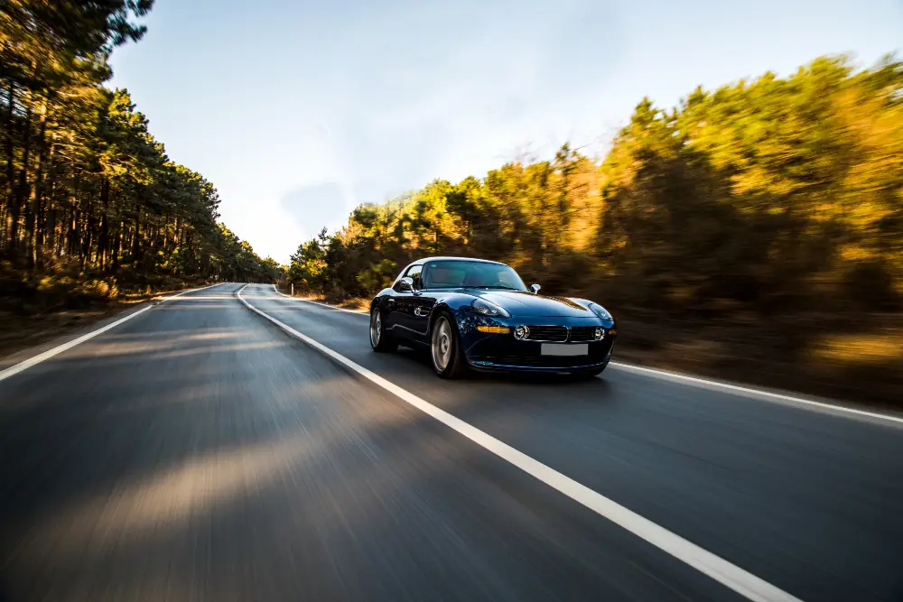 Black-luxurious-sport-car-driving-across-the-forest