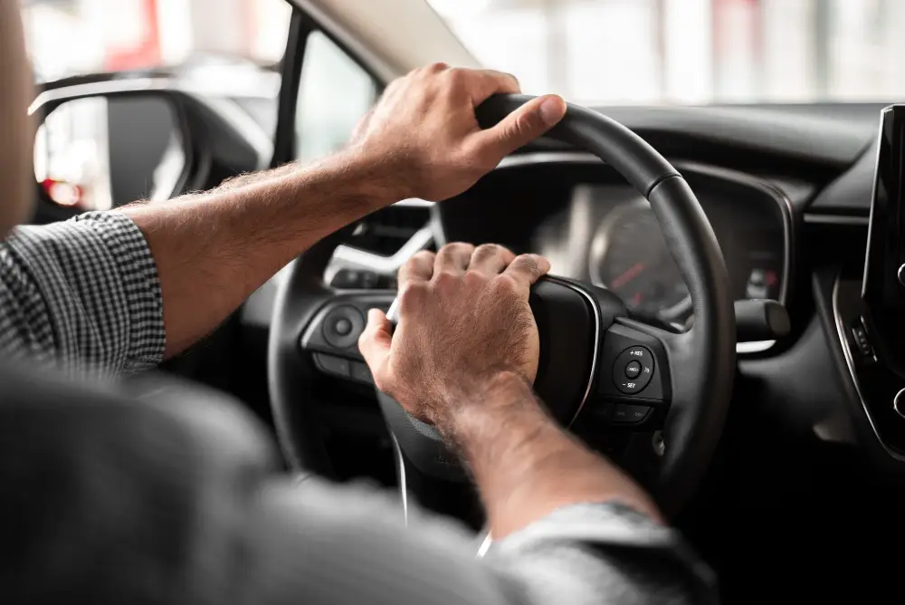 Closeup-of-man-hands-on-a-car-wheel