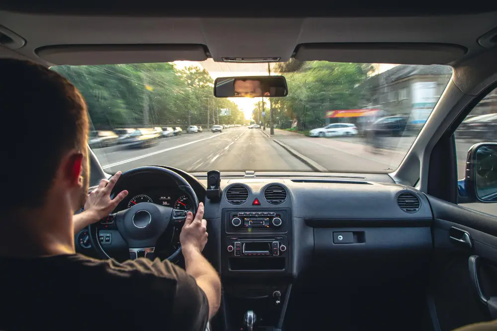 Hands-on-wheel-while-driving-on-a-highway