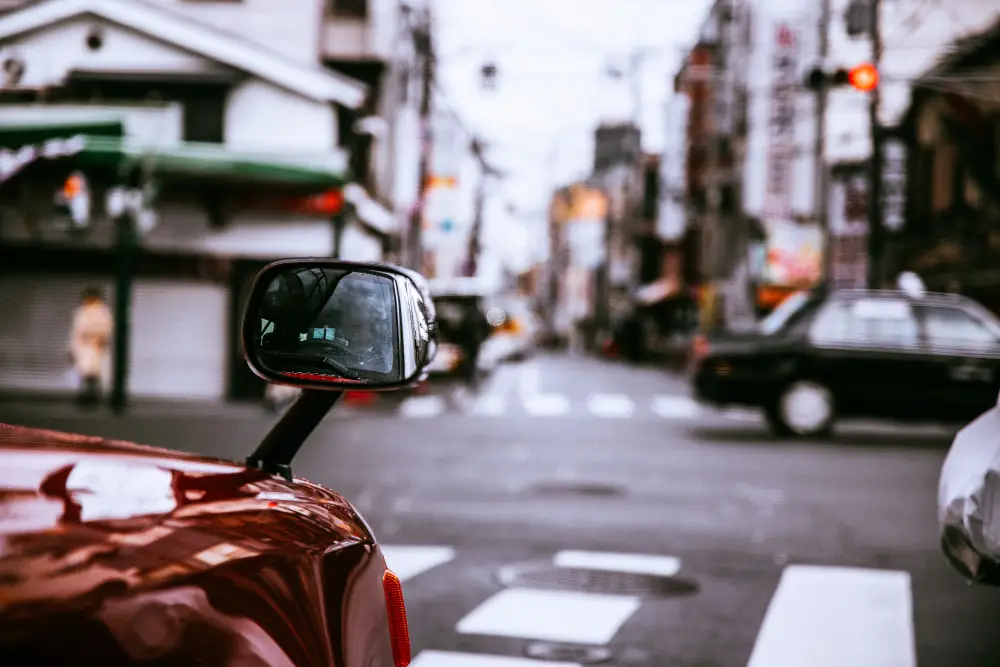 Selective-closeup-shot-of-a-red-car's-side- mirror